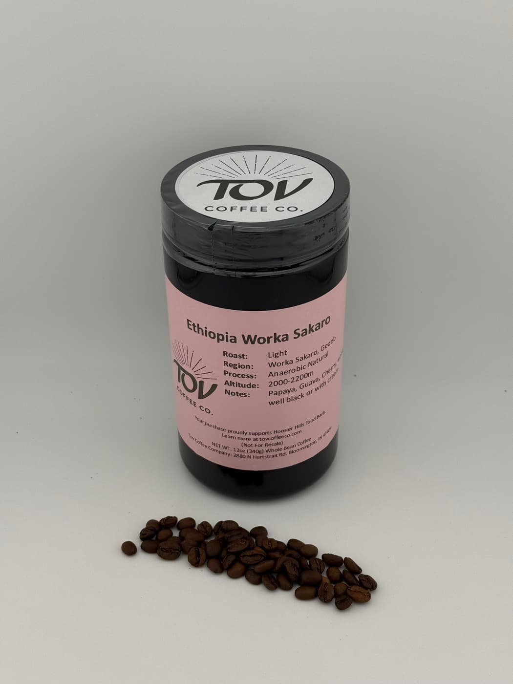 A 12oz jar of Tov Ethiopia Worka, with roasted beans beside it.